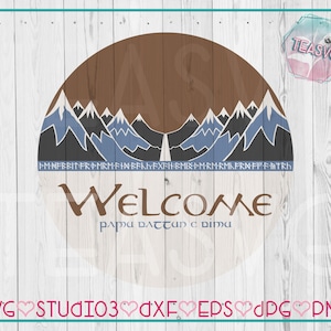 May include: A wooden sign with a brown mountain range design and the word "WELCOME" in a stylized font. The sign also includes text in a different language and the words "SVG STUDIO3 DXF EPS JPG PNG".