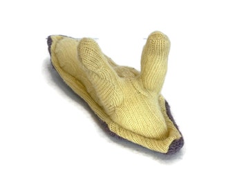 May include: A hand-knitted yellow slug with a purple trim. The slug has two small, rounded bumps on its back.