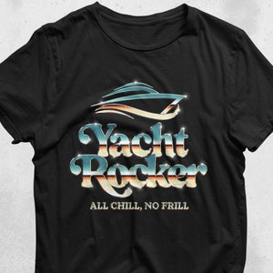 May include: Black t-shirt with a silver and blue graphic of a yacht with the text "Yacht Rocker" and "All Chill, No Frill" underneath.