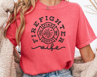 May include: A red t-shirt with a black firefighter emblem and the text "Firefighter wife".