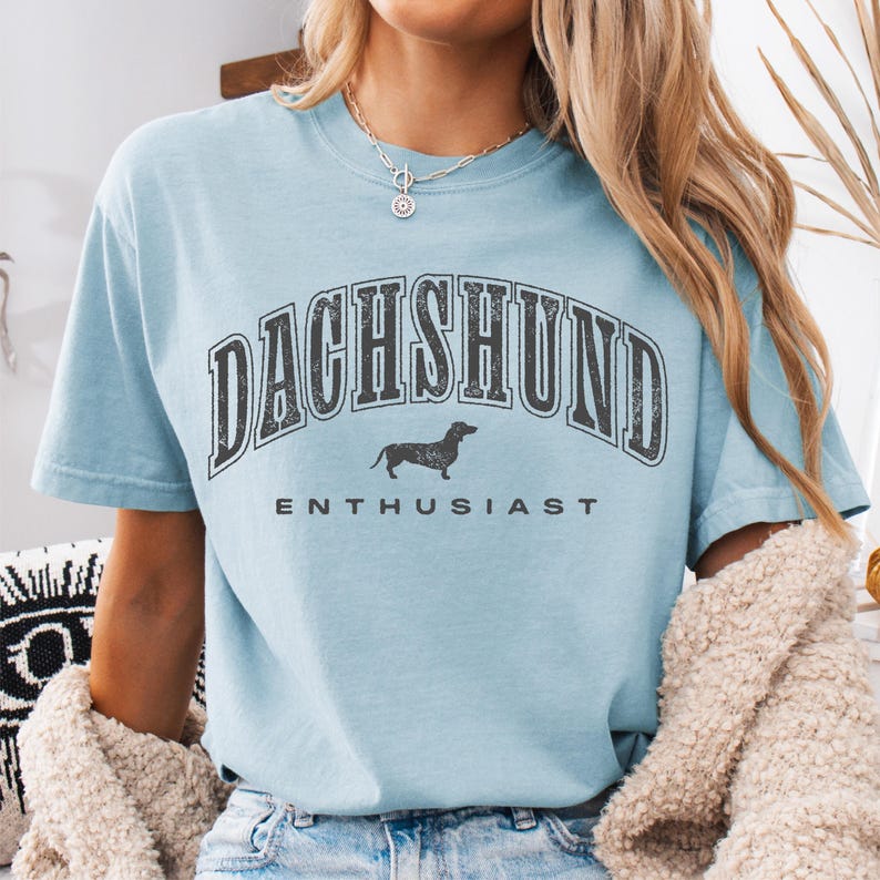 a woman wearing a blue shirt with a dachshund print