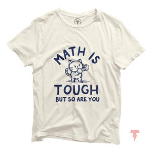 May include: White t-shirt with a blue graphic of a cat wearing boxing gloves and the text "Math is tough but so are you."