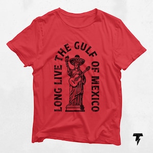 a red t - shirt with a statue of liberty holding a guitar