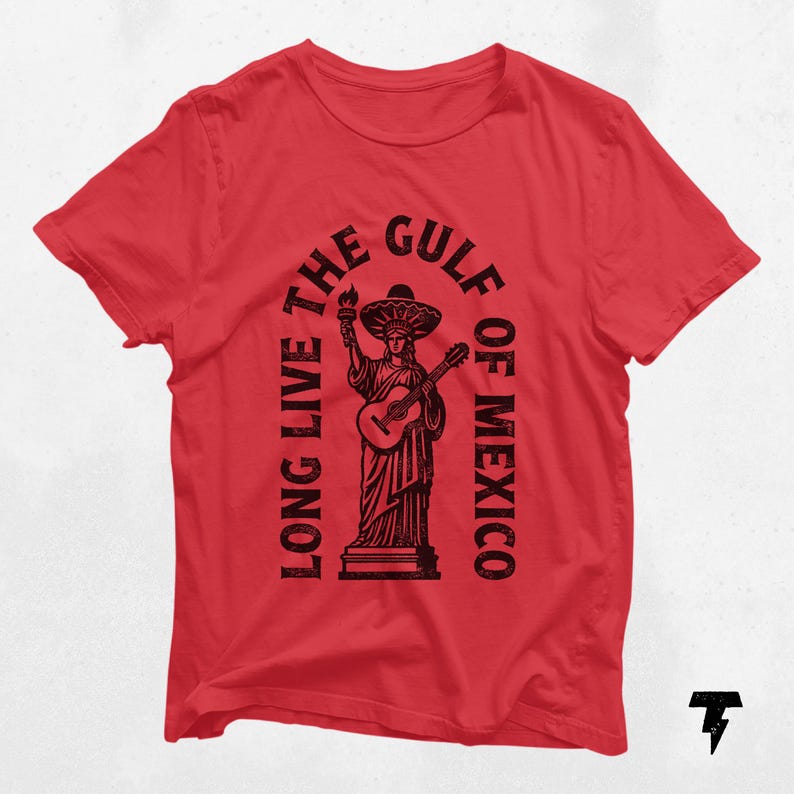a red t - shirt with a statue of liberty holding a guitar