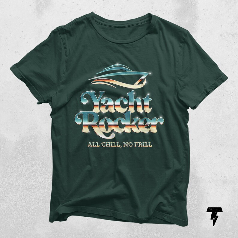 May include: A dark green t-shirt with a silver and blue graphic of a yacht with the text "Yacht Rocker" and the phrase "All Chill, No Frill" underneath.