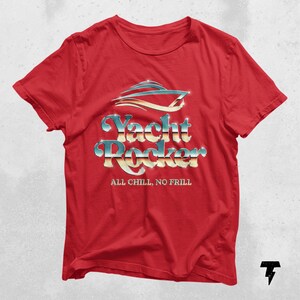 May include: Red t-shirt with a silver and blue graphic of a yacht with the text "Yacht Rocker" and the words "All Chill, No Frill" underneath.