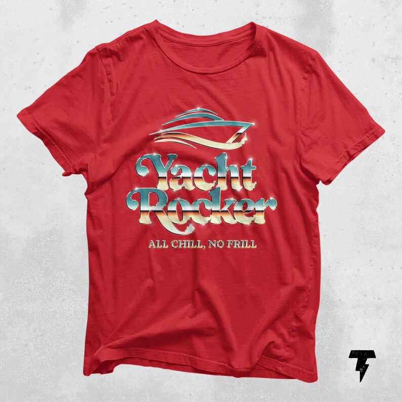 May include: Red t-shirt with a silver and blue graphic of a yacht with the text "Yacht Rocker" and the words "All Chill, No Frill" underneath.