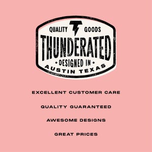 May include: Black and white logo with the text "QUALITY GOODS THUNDERATED DESIGNED IN AUSTIN TEXAS" in a distressed font. The logo is surrounded by a thick black border. Below the logo, the text "EXCELLENT CUSTOMER CARE QUALITY GUARANTEED AWESOME DESIGNS GREAT PRICES" is written in black.