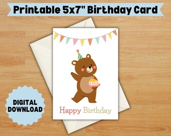 May include: Printable 5x7 inch birthday card featuring a brown bear wearing a party hat and holding a pink and yellow cake with a single candle. The card has a banner of colorful flags at the top and the words "Happy Birthday" at the bottom.