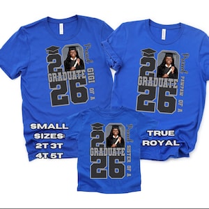 May include: Royal blue t-shirts with a graduation theme. Each shirt features a photo of a graduate, the text "2026 GRADUATE", and the words "Proud" and a family member's title. Sizes include 2T, 3T, 4T, and 5T.