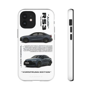 May include: White phone case with images of a grey Audi RS3 saloon car. Text includes "Audi RS3 Saloon", "Kemora Grey", and "Vorsprung Edition". The case also has a side view.