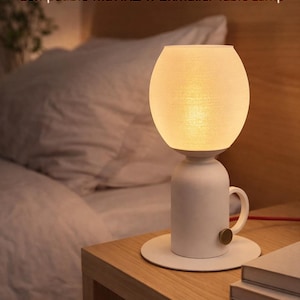 May include: A white table lamp with a textured lampshade. The lamp has a cylindrical base with a handle and a brass-coloured knob. The text on the image reads "Replacement Lamp Globe" and "Compatible with IKEA Äskmuller Table Lamp."