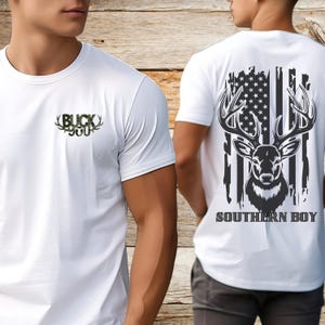 May include: White t-shirt with a camouflage print of a buck's antlers and the text "BUCK 300". The back of the shirt features a distressed American flag with a deer head and the text "SOUTHERN BOY".