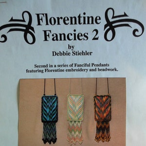 May include: Three beaded necklaces with colorful geometric patterns and fringe. The necklaces are displayed on a brown background. The text "COPYRIGHT 1995. All rights reserved. This booklet may not be reproduced in any form or by any means, in part or in whole, without the written permission of the author." is printed below the necklaces.