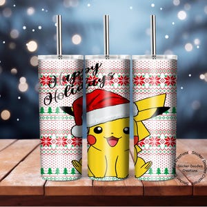 May include: Three stainless steel tumblers with a white background and a red and green Christmas pattern. The tumblers feature a cartoon image of Pikachu wearing a Santa hat. The text "Happy Holidays" is printed on one of the tumblers.
