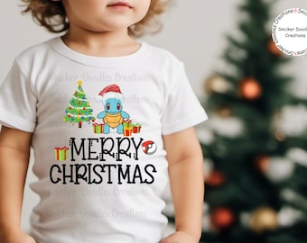 May include: A white toddler t-shirt with a Christmas tree, a Squirtle Pokemon character wearing a Santa hat, and the text "Merry Christmas".