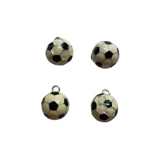 May include: Four soccer ball charms with black and white panels. Each charm has a silver-colored loop at the top for attaching to a necklace or bracelet. The charms are set against a white background.