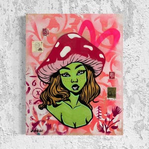 May include: A green-skinned woman with brown hair wearing a pink and red mushroom hat. The background is a pink and white floral pattern with a pink spray paint design.
