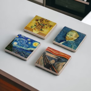 May include: Four square ceramic coasters featuring famous paintings by Vincent van Gogh. The coasters depict "Starry Night", "Sunflowers", "The Scream", and a self-portrait of the artist.