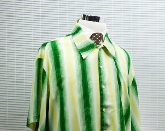 May include: A green and yellow striped short-sleeved button-down shirt with a brown polka dot tie.