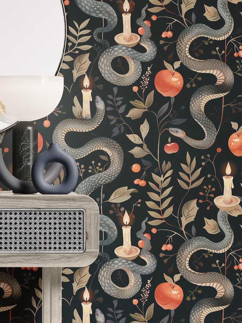 May include: Dark, patterned wallpaper featuring gray snakes, red apples, and lit candles against a black background. The design includes leaves and berries. A wooden shelf with a woven front and decorative vases is in the foreground.