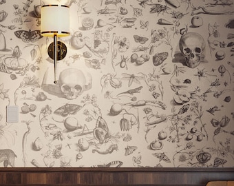 May include: A wall with a detailed black and white botanical and skull pattern. A wall sconce with a cream-colored shade and gold accents is mounted on the wall. The lower portion of the wall is dark wood paneling.