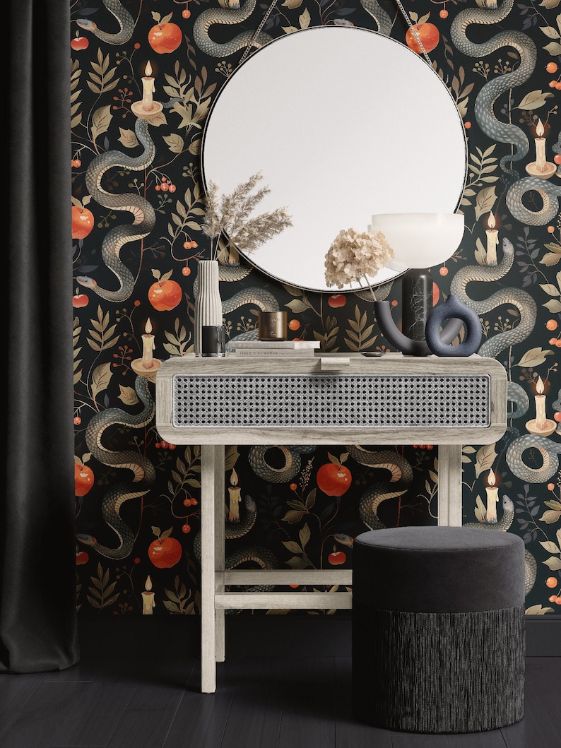 May include: A vanity set with a round mirror, a light wood table with a woven front, and a matching stool with fringe. The wallpaper features a dark background with snakes, apples, and candles.