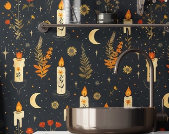 May include: A black and gold bathroom with a dark floral wallpaper featuring candles, moons, and stars. A gold metal sink is on a dark wood countertop.