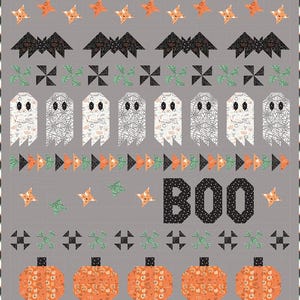 May include: A Halloween-themed quilt with a gray background. The quilt features orange stars, black bats, green cross shapes, white ghosts, orange triangles, and orange pumpkins. The word "BOO" is spelled out in black letters.