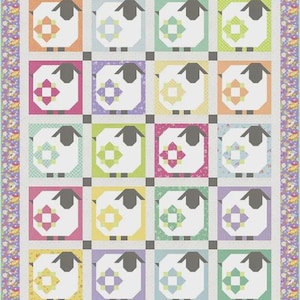 May include: A quilt featuring a grid of twenty sheep blocks, each with a white body and dark gray head and legs. Each sheep has a colorful patterned square on its side. The quilt is bordered by a purple floral fabric and a light gray frame.
