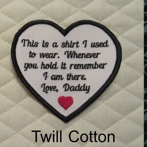 May include: Heart-shaped patch with black trim and the text "This is a shirt I used to wear. Whenever you hold it remember I am there. Love, Daddy." A red heart is embroidered at the bottom. The words "Twill Cotton" are at the bottom.