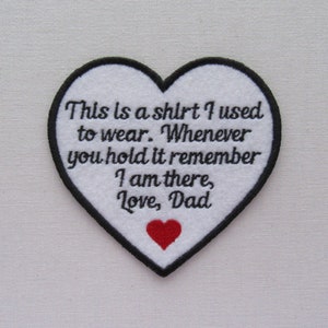 May include: White heart-shaped patch with black stitching and the text "This is a shirt I used to wear. Whenever you hold it remember I am there, Love, Dad". A small red heart is stitched in the bottom center of the patch.