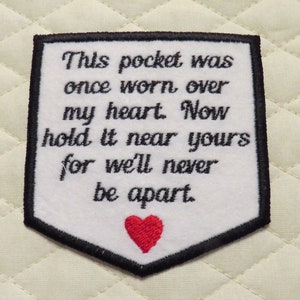May include: White felt patch with black embroidered text that reads "This pocket was once worn over my heart. Now hold it near yours for we'll never be apart." A red felt heart is embroidered at the bottom of the patch.