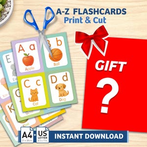 May include: A set of A-Z alphabet flashcards with illustrations of an apple, ball, cat, and dog, accompanied by blue-handled scissors. A red square with a white bow and a question mark is present. Text includes A-Z FLASHCARDS Print & Cut, GIFT, and A4 + US LETTER INSTANT DOWNLOAD.