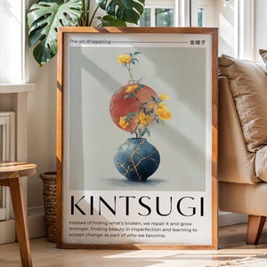 May include: A framed art print featuring a Kintsugi design. The artwork depicts a red and yellow sphere above a blue vase with gold accents, holding yellow flowers. Text at the bottom reads "KINTSUGI". The frame is wooden.