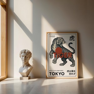 May include: A framed poster with a tiger illustration in black, gray, and red. The word "TIGER" is prominently displayed, along with Japanese text and the year "1988". A classical bust is to the left.