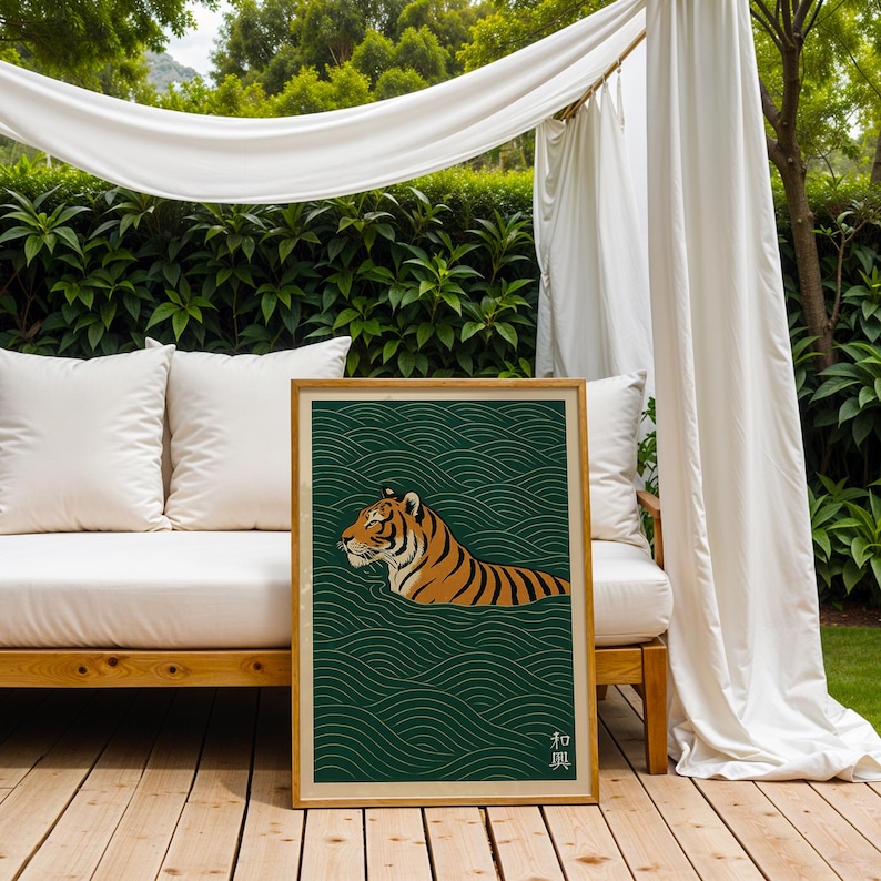 May include: A framed art print featuring a tiger swimming in water. The tiger is orange and black, set against a dark green background with a wave pattern. The frame is a light brown color.