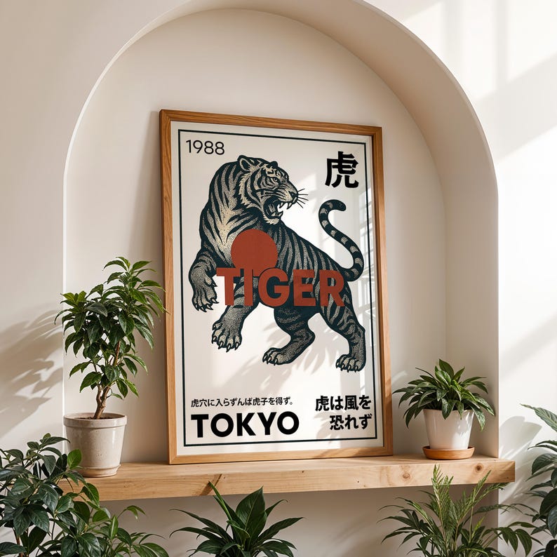 May include: A framed art print featuring a detailed illustration of a tiger in black and gray with the word "TIGER" in red. The print includes Japanese text and the year "1988". The artwork is displayed on a wooden shelf with potted plants.