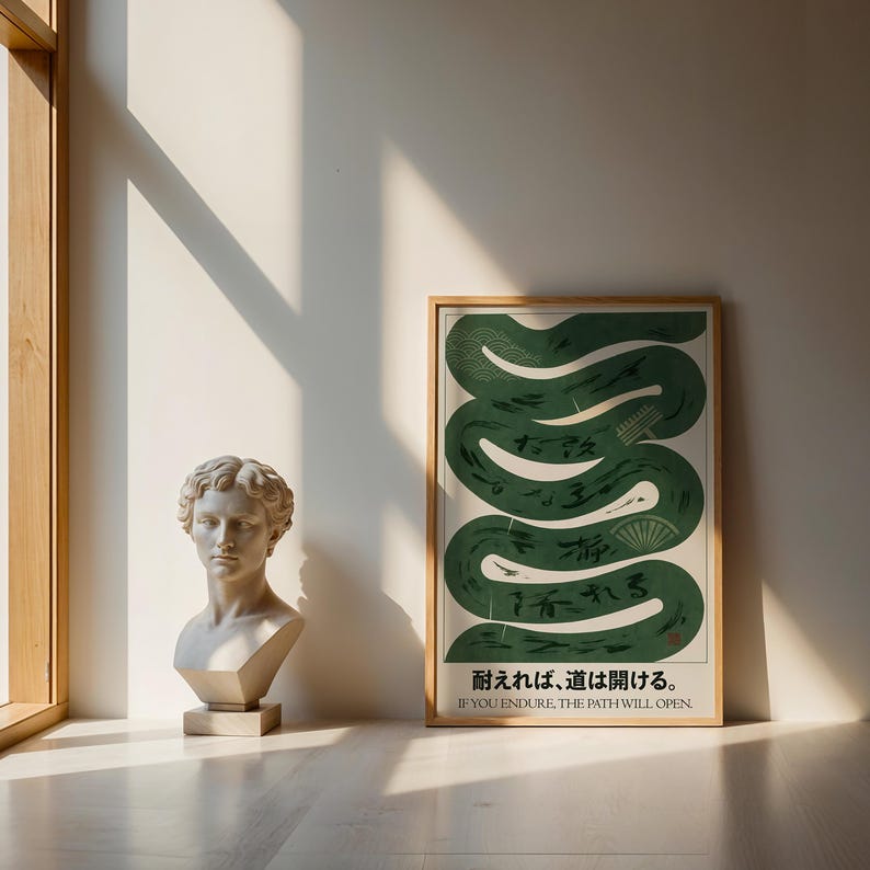 May include: A framed poster with a green, stylized snake design and Japanese text. The poster is in a light wood frame and has the English text "IF YOU ENDURE, THE PATH WILL OPEN" at the bottom. A classical bust is to the left.