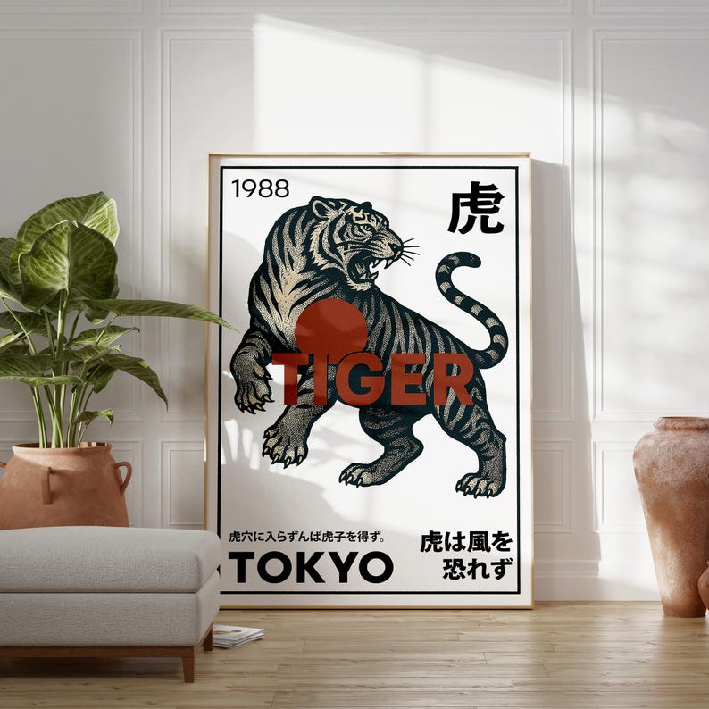 May include: A framed art print featuring a black and white illustration of a tiger with the word "TIGER" in red. The print includes the year "1988" and Japanese text, with "TOKYO" at the bottom. The artwork is displayed in a room setting.