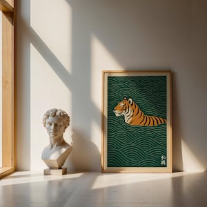 May include: A framed art print featuring a tiger swimming in stylized green water. The tiger is orange and black, with a detailed illustration. The print has a wooden frame and is displayed near a classical bust.