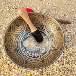 Handcrafted Tibetan Singing Bowl with Engraved Deity