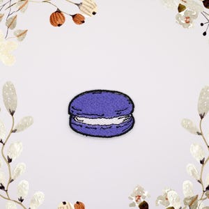 May include: Purple embroidered iron-on patch of a macaron cookie.