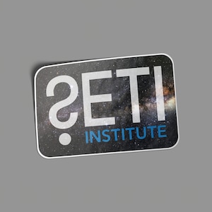 May include: A sticker with a starry night sky background and the text "?SETI INSTITUTE" in white and blue.