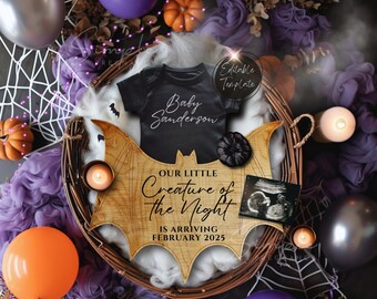 May include: A wooden bat-shaped sign with the text "Our Little Creature of the Night is Arriving February 2025". A black onesie with the text "Baby Sanderson" is on top of the sign. The sign is surrounded by purple fabric, orange pumpkins, and a black and white ultrasound image.