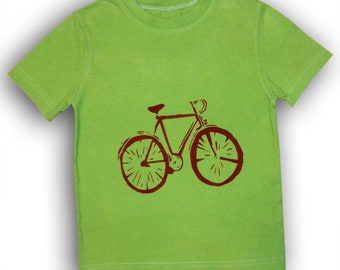 May include: A lime green t-shirt with a brown bicycle graphic printed on the front.