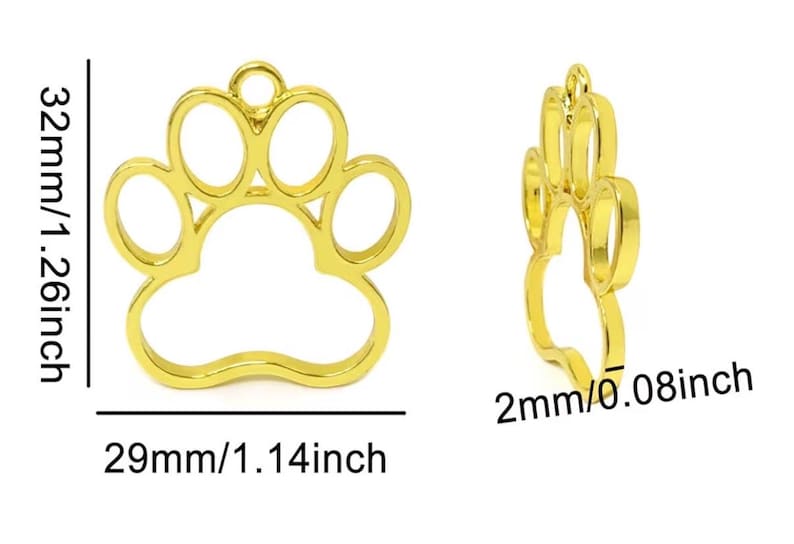 May include: A gold-colored metal paw print charm frame with an open center. The charm measures 32mm (1.26 inches) in height, 29mm (1.14 inches) in width, and has a thickness of 2mm (0.08 inches), featuring a small loop at the top for attachment.