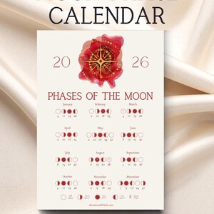May include: A cream-colored Moon Phase Calendar for 2026, featuring a red floral design with gold accents. The calendar displays the phases of the moon for each month, with dates and moon phase illustrations. The text "MOON PHASE CALENDAR" is at the top.