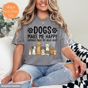 May include: Graphite heather t-shirt with the text "DOGS MAKE ME HAPPY HUMANS MAKE MY HEAD HURT". The shirt features a graphic of several different dog breeds. The shirt is a crew neck and has short sleeves.