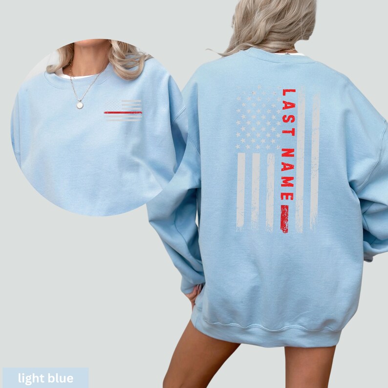 a woman wearing a light blue sweatshirt with an american flag on it